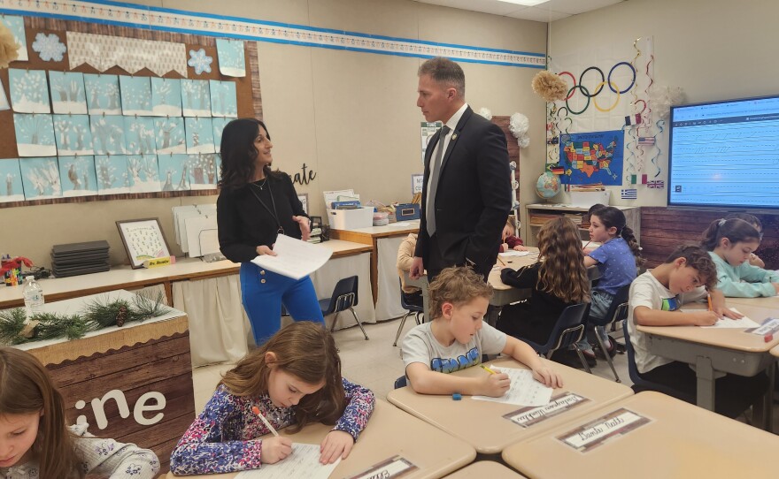 State Rep. Dane Watro learns about Diane Mussoline’s cursive lessons in her classroom at Valley Elementary/Middle School.