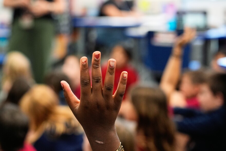 A student raises her hand 