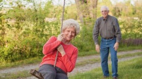 Amy's gran, Marilyn Calvert, swings on a tree swing with her papaw, Perry Calvert, smiling in the background.