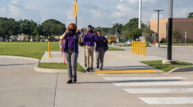  Students put on their face masks as they approach Edna Karr High School on the first day of the 2021-22 school year. Aug. 2, 2021.
