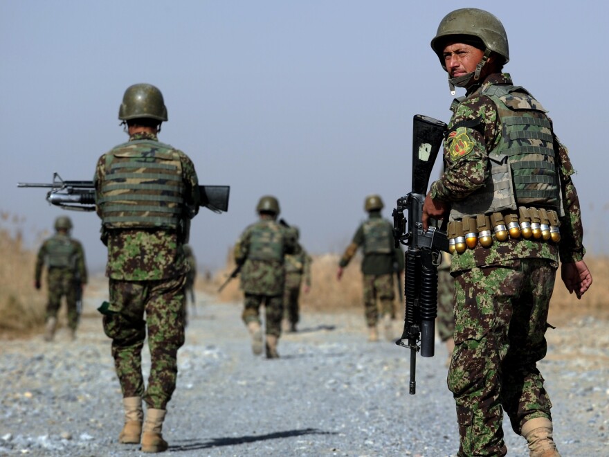 Afghan soldiers patrol a rural road near in southern Afghanistan. U.S. forces will continue to train Afghans on logistics and intelligence collection.