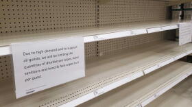 Shelves sit empty at a Target in the Indianapolis area with signs informing customers of limits on the number of products they can buy at a time.