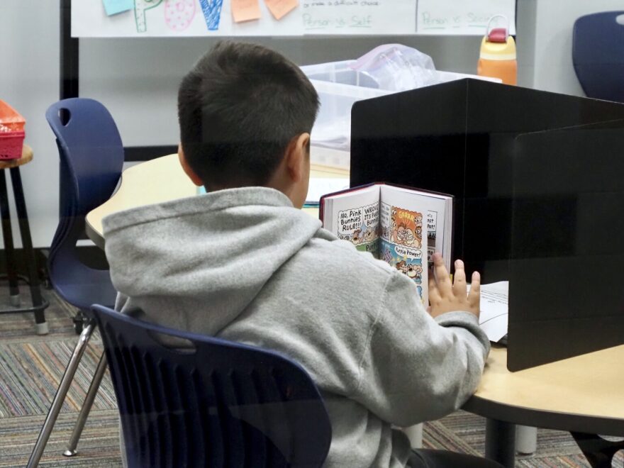 A student reads a graphic novel at Hills Elementary in Santa Fe South Charter Schools on Aug. 4 in Oklahoma City.