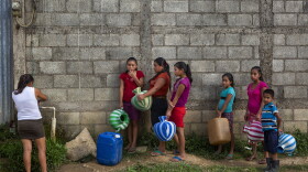 In this photo from May 2019 women wait to collect water in the village of El Tesoro, in Guatemala. Experts say climate change means more extreme weather, and Guatemala lacks the resources, and, critics say, political will to help impoverished areas.