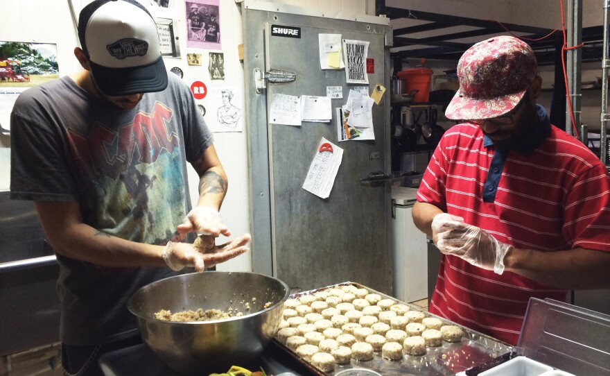 Roberto Diaz and Manuel Vasquez prepare croquettes made from green bananas and quinoa in the kitchen of <em>El Departamento de la Comida, </em>a farmers market and restaurant in San Juan.