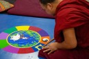 One monk works on adding the ten religious symbols representing various religions around the world to the mandala on Tuesday. Once completed, various parts of the mandala will symbolize working together and peacefulness.