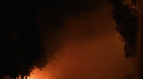 A Ukrainian army checkpoint burns on the road to Russia after loud explosions were heard on the outskirts of Mariupol late Saturday.