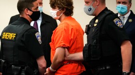 Payton Gendron (seen in orange) being is led out of the courtroom after a hearing at Erie County Court, in Buffalo, N.Y., on May 19, 2022. Gendron faces charges in the May 14, fatal shooting at a supermarket. Gendron is expected to plead guilty on Monday to state charges against him.