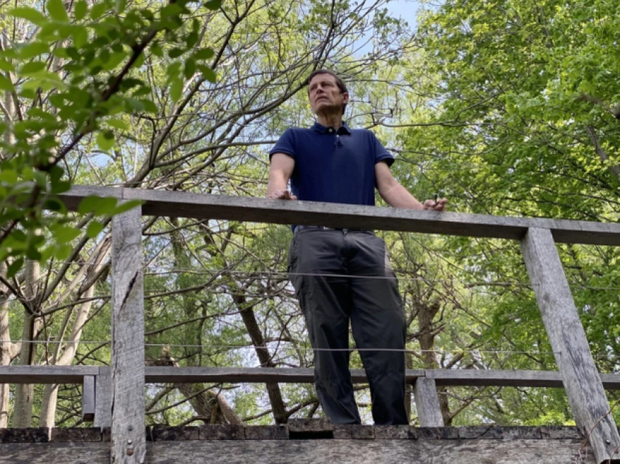 Andy Zepp, Finger Lakes Land Trust executive director, stands on a bridge that stretches over a tributary of Skaneateles Lake.
