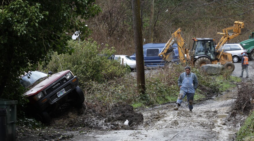 City of Seattle workers clear debris from a mudslide in Seattle's Magnolia neighborhood March 2011, in Seattle. Will La Nina lead to an encore of flooding and slides this year?