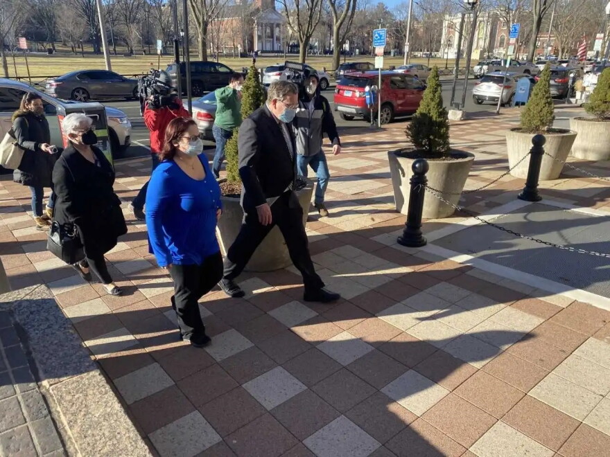 Lauren Knox, the wife of former state Democratic lawmaker Michael DiMassa, leaves the federal courthouse in New Haven with her mother and attorney. Knox, who now goes by Lauren DiMassa, pleaded guilty to a federal conspiracy charge on July 12, 2022.