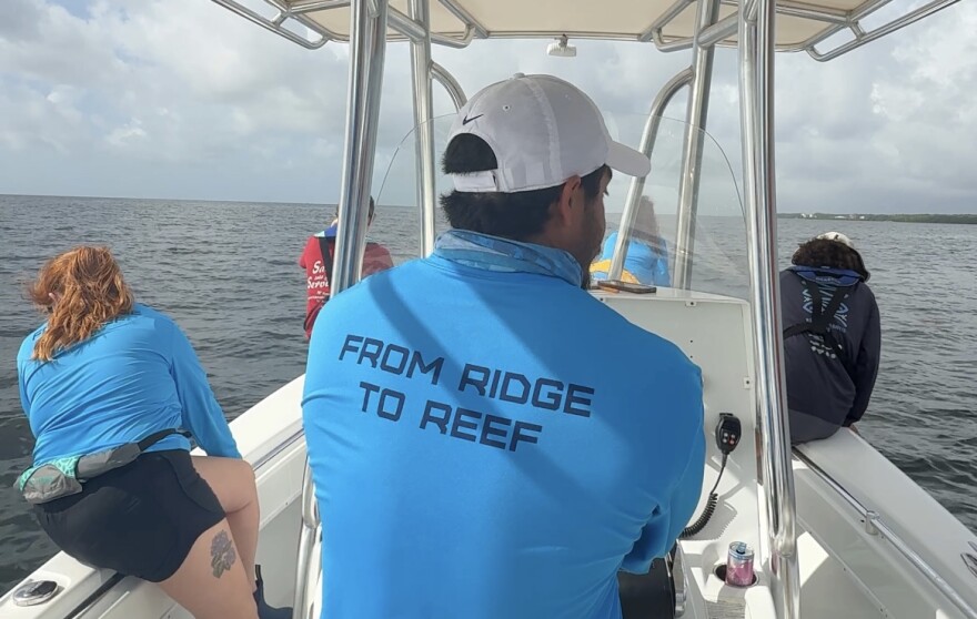 Nicholas Evans, along with FIU's Institute of Environment researchers, searching for traps on the university's research vessel.