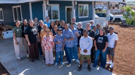 The Yadao family (center) at their rebuilt Lahaina home, with Mennonite Disaster Services volunteers and Hoʻōla iā Mauiakama Disaster Long Term Recovery Group staff that helped them rebuild.