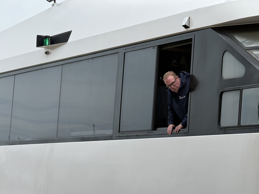 Captain Perry Dunbar looks out a window as his mate and deckhand secure the Manhattan Elite.