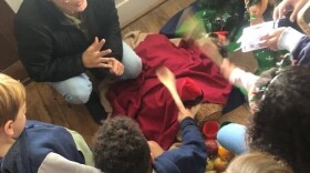 Laia Vicens Fuste held a holiday party with the Casal dels Catalans de California,a local Catalan culture group. There, kids participated in the Tió de Nadal tradition. Laia's own kids speak English, Spanish and Catalan, and she says passing down cultural traditions is an important way she stayed connected to her roots while she lived in the U.S. (Courtesy of Laia Vicens Fuste)