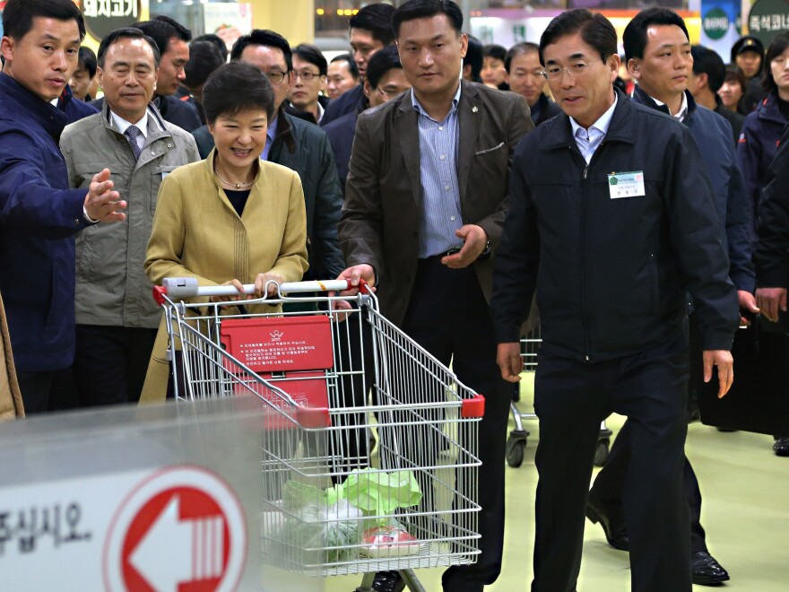 South Korean President Park Geun-hye pushes a cart in a store in the capital, Seoul. In remarks Wednesday, North Korea referred to the "venomous swish" of her skirt.