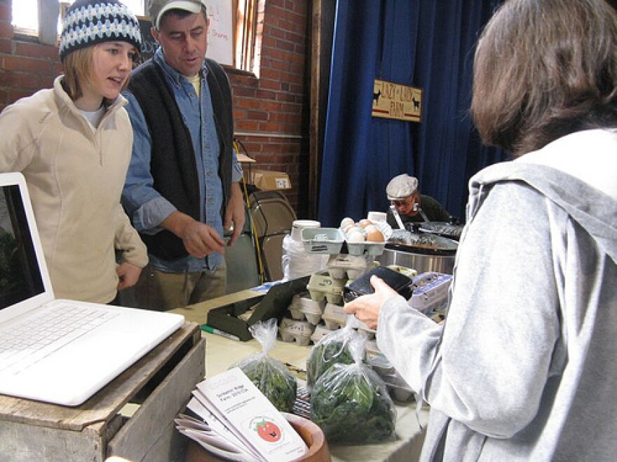Joe Buley and his daughter Anik sell greens at the Montpelier Winter Farmers Market.