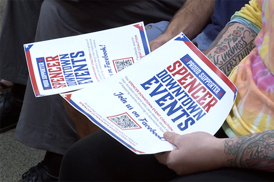 Residents hold Spencer Downtown Event Coalition flyers during the Sept. 9 meeting of the Owen County Commissioners