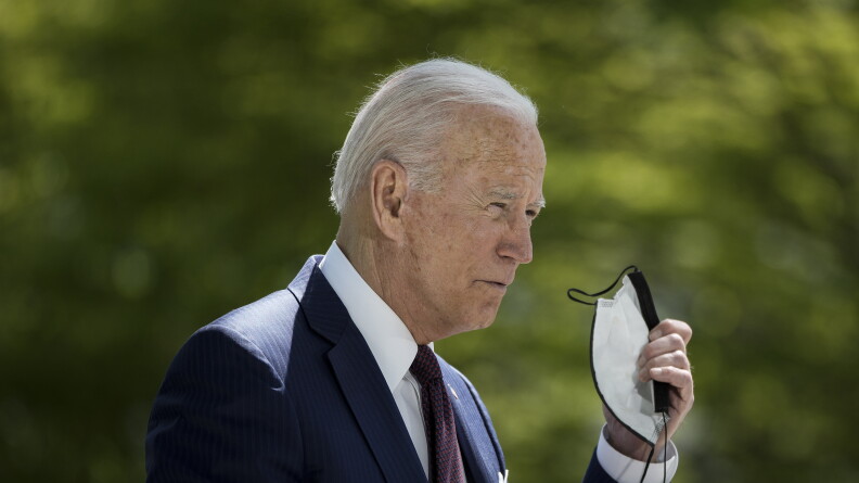 President Biden removes his mask before speaking about the pandemic outside of the White House on Tuesday afternoon.