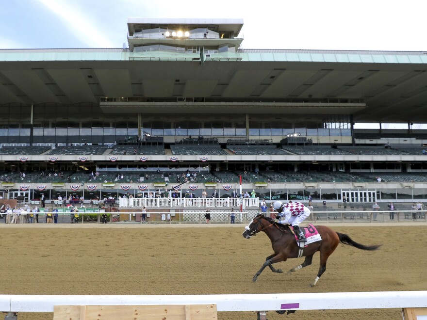 Tiz the Law, with jockey Manny Franco, crosses the finish line Saturday in front of an empty grandstand to win the 152nd running of the Belmont Stakes horse race in Elmont, N.Y.