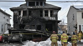 Firefighters from the Kingston Forty Fort Fire Department observe the scene of a fatal fire on N. Welles Street in Kingston.