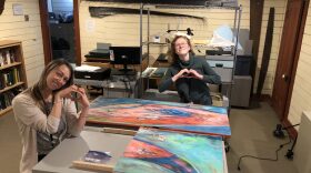 Kodiak History Museum executive director Sarah Harrington and collections curator Margaret Greutert pose with a new addition to the museum’s collection, “It’s All Love Now” by local artist Lena Amason-Berns. (Photo courtesy Sarah Harrington)