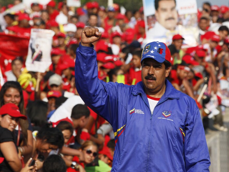 Nicolas Maduro, Venezuela's acting president and Chavez's hand-picked successor, raises his fist during a presidential election campaign rally in Catia La Mar, Venezuela, on Tuesday.