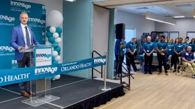 Patrick Blair speaks a podium.