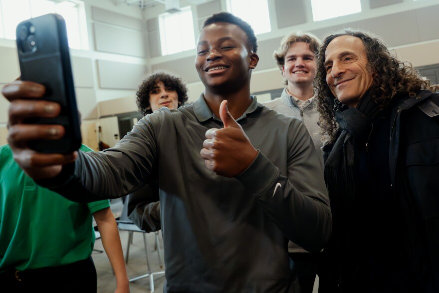 Jackson Brandon, a junior at Christian Brothers College High School, takes a selfie with Grammy Award-winning saxophonist Kenny “G” Gorelick on Wednesday, Dec. 3, 2025, at the school in Town and Country. 