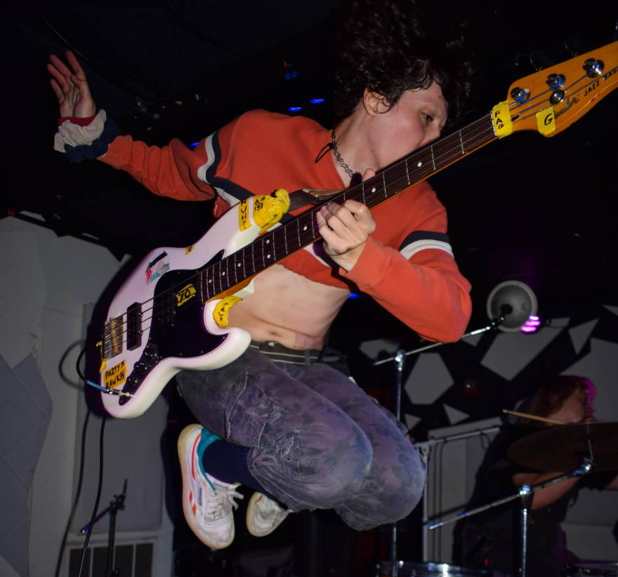 Iss Manzi, bassist and vocalist of Film and Gender, jumps as he plays bass at No Fun on Sept. 24, 2026
