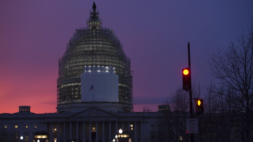 The U.S. Capitol is seen at dusk Thursday. The House approved a massive spending bill just hours before a midnight deadline to fund the federal government.