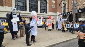 Protesters use several oversized puppets of real estate executive Carl Montante to act out a skit describing their criticisms of Montante, namely renting out offices to ICE