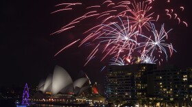 Fireworks explode over the Sydney Opera House and Sydney Harbour Bridge during New Year's Eve celebrations in Sydney, Australia.