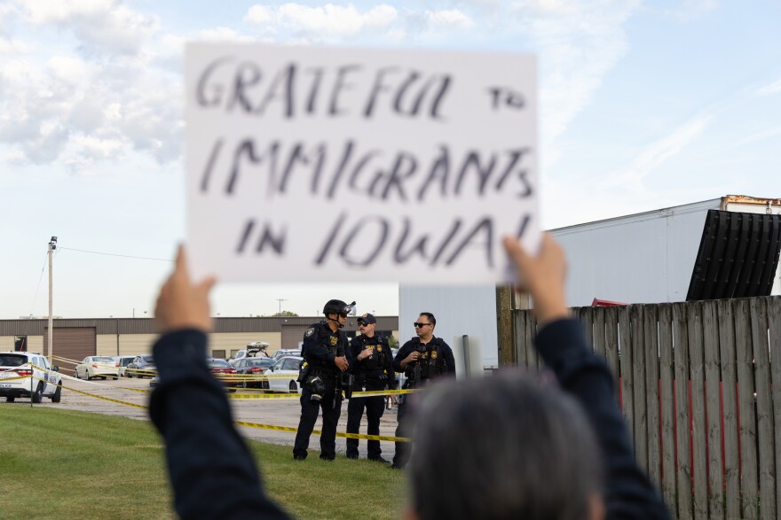 Three federal officers in tactical gear stand near a perimeter line around the Cedar Rapids ICE Field Office on Tuesday, Sept. 2, 2025, in Cedar Rapids, Iowa.