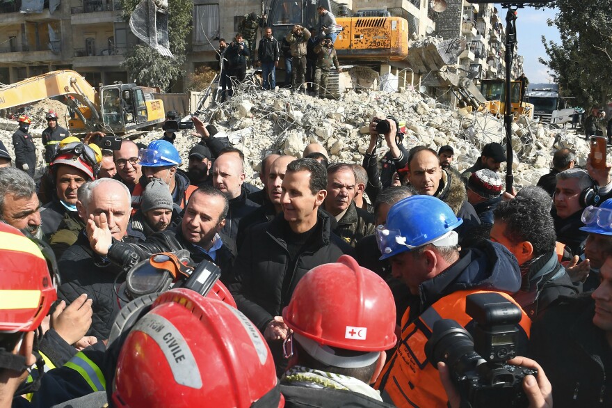 Syrian President Bashar al-Assad (center) visits neighborhoods affected by the earthquake in the northern city of Aleppo.