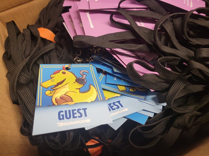 Color-coded guest passes and lanyards stacked before distribution for SwampCon.