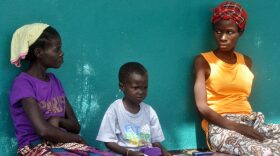Pictured: Three people suspected of having contracted the Ebola virus await treatment near Monrovia, Liberia. (Abbas Dulleh/AP)