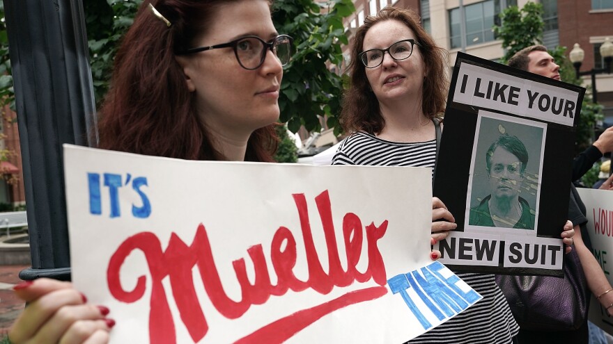 Activists hold signs — one referencing special counsel Robert Mueller — outside the Alexandria, Va., courthouse as Manafort's trial began this week.