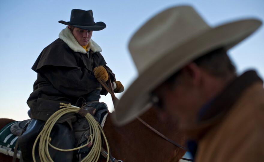 Rancher Dave Baker and his son, Clay, get ready to herd 200 cattle on their ranch in Baker, Nev.