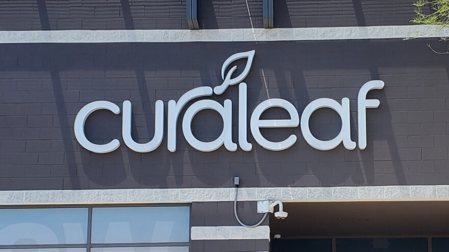 The front of a brown building that says Curaleaf. 