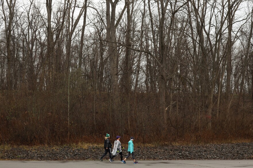 3 people walking in greece canal park