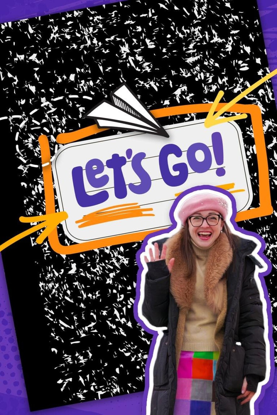 "Let's Go!" in large purple lettering on a composition notebook. In front of the notebook, is a woman in a pink hat and a black jacket. 