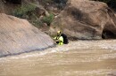 A member of a search and rescue team wades in to Virgin River during a search Wednesday, Sept. 16, 2015, in Zion National Park, near Springdale, Utah. Seven hikers who entered a narrow desert canyon for a day of canyoneering became trapped when a flash flood filled the chasm with water, killing at least five of them in Zion National Park in southern Utah, officials said Wednesday.