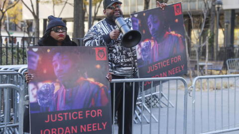 Protesters hold "Justice for Jordan Neely" signs after Daniel Penny arrives at court, Friday, Dec. 6, 2024, in New York. (Heather Khalifa/AP)
