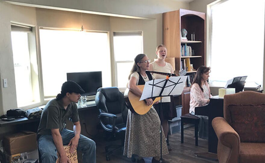 A small group of musicians plays music for those in attendance on a Sunday morning at Brody and Liz Olson's home.