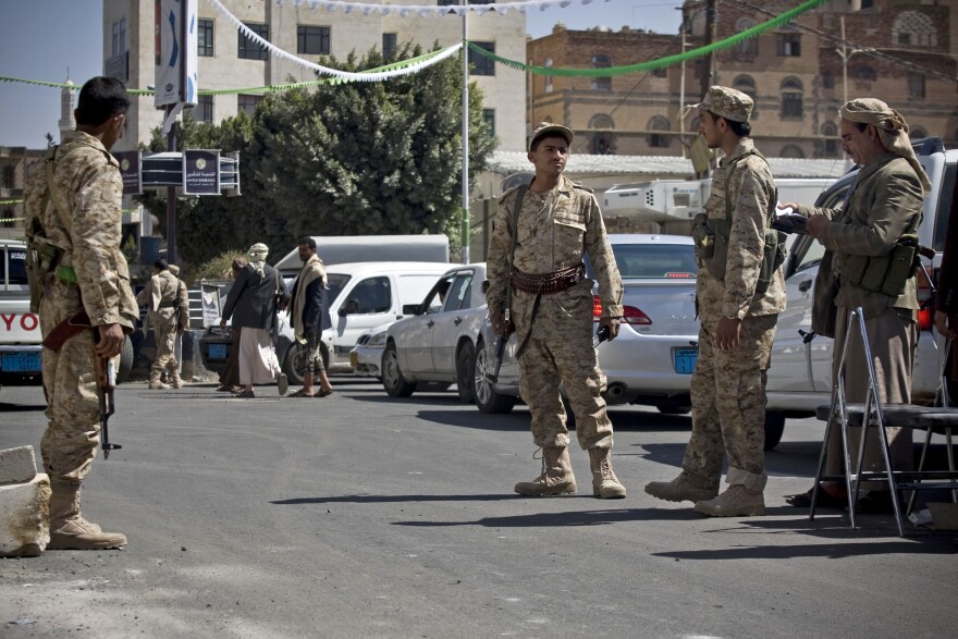 Shiite Houthis wearing Yemeni army uniforms stand guard on a street leading to the presidential palace in Sanaa, Yemen, on Wednesday.