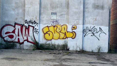 Graffiti pictured on a building near the corner of Wayne Avenue and Jones Street. The city of Dayton has been encouraging people to report graffiti so it can be removed.