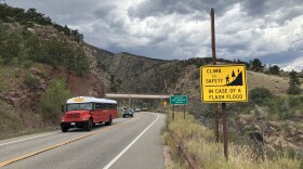 A sign posted along U.S. Highway 34 at the bottom of Big Thompson Canyon warns drivers to "climb to safety in case of a flash flood." On July 31, 1976 a massive flood in the canyon killed 144 people.
