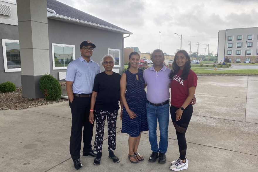 Lay and Khushi with their parents and grandmother outside the hotel their parents own.