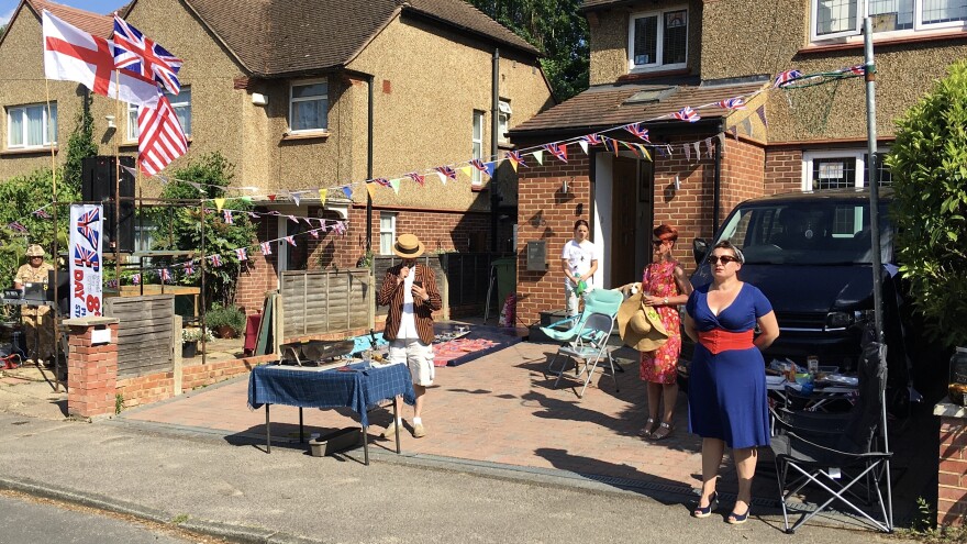 Neighbors in the town of Weybridge outside of London blasted World War II-era tunes and some dressed in 1940s clothing as they held a socially distanced block party to celebrate V-E Day.